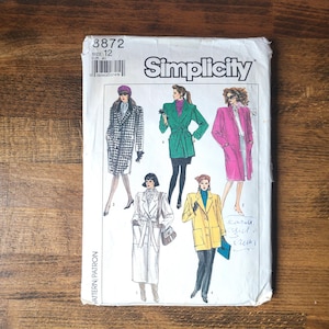 May include: Simplicity sewing pattern number 3872, size 12, for a coat. The pattern shows four different styles of coats, including a black and white checked coat, a green coat with a belt, a pink coat, and a white coat with a belt.