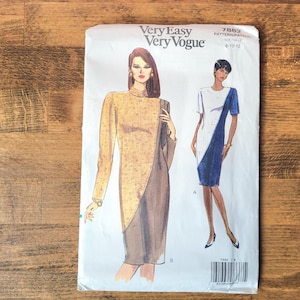 May include: A Very Easy Very Vogue sewing pattern envelope 7882 for sizes 8-10-12. The front features illustrations of two dresses: one long-sleeved gold and brown dress, and one short-sleeved white and blue dress with a diagonal colour-blocked design.