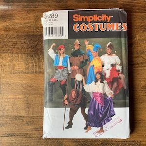 May include: A Simplicity Costumes sewing pattern envelope, number 7289, featuring illustrations of various historical and fantasy-themed outfits. The package displays multiple figures in colorful attire, including a pirate, a jester, and a dancer.