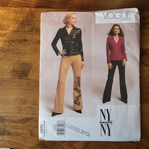 May include: Vogue Patterns sewing pattern for a pair of pants and a jacket. The pattern is for sizes 8-18. The pattern is for a pair of pants with a wide leg and a jacket with a collar and a button closure. The pattern is printed on white paper with black text. The pattern is for a woman.