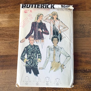 May include: A vintage Butterick sewing pattern envelope, featuring illustrations of women's jackets. The envelope displays the number 6846 and size 12. The jackets are in various styles, including a velvet jacket and a striped jacket.