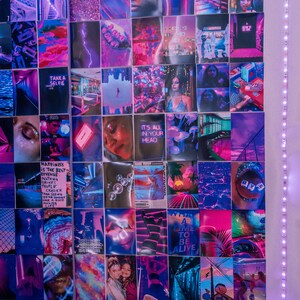 May include: A wall collage of colorful images with a pink, purple, and blue color scheme. The images include a variety of subjects, such as people, landscapes, and abstract designs. The collage is hung on a white wall and is surrounded by a string of white lights.