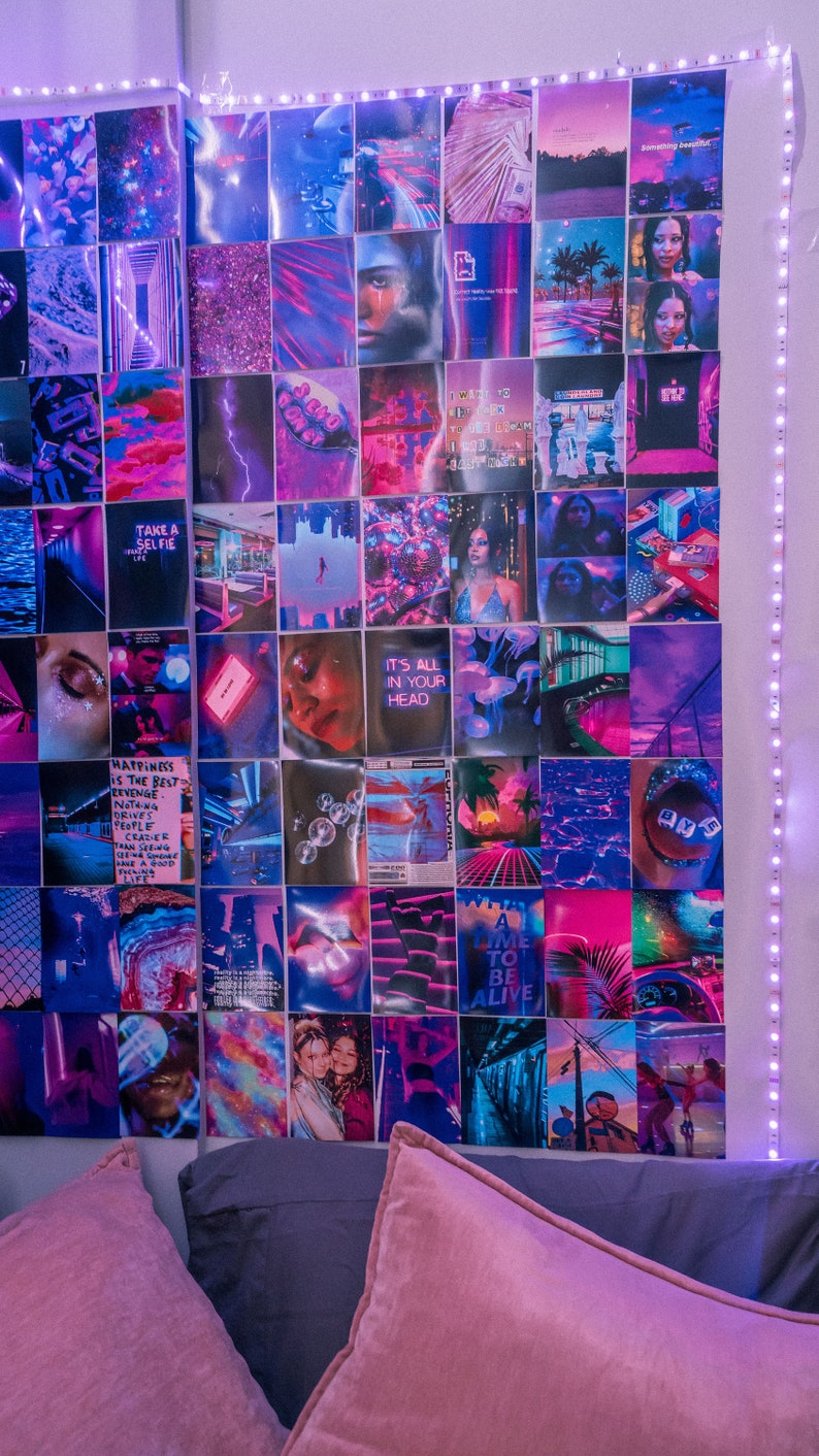 May include: A wall collage of colorful images with a pink, purple, and blue color scheme. The images include a variety of subjects, such as people, landscapes, and abstract designs. The collage is hung on a white wall and is surrounded by a string of white lights.