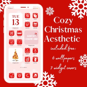 May include: A pink iPhone screen with a Christmas aesthetic theme. The screen displays a calendar with the date "TUE 13", and various app icons with a Christmas theme, including a Santa hat, a Christmas tree, and a pizza slice. The text "Cozy Christmas Aesthetic" is displayed in white letters on a red background, along with the text "included free: 6 wallpapers 7 widget covers".