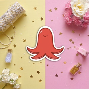 May include: A red cartoon octopus with a simple face on a pink and yellow background with gold stars.