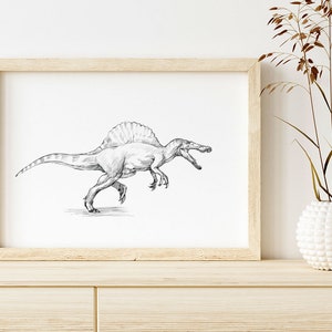 May include: A black and white pencil drawing of a Spinosaurus dinosaur in a light wood frame. The drawing is on a white background and is hanging on a white wall.