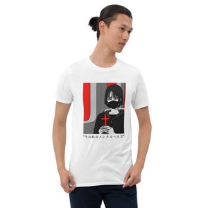 May include: A white short-sleeve t-shirt featuring a graphic print of a person with short dark hair wearing a black face mask. The person holds a bright red cross. The design includes red and grey background elements and Japanese text.