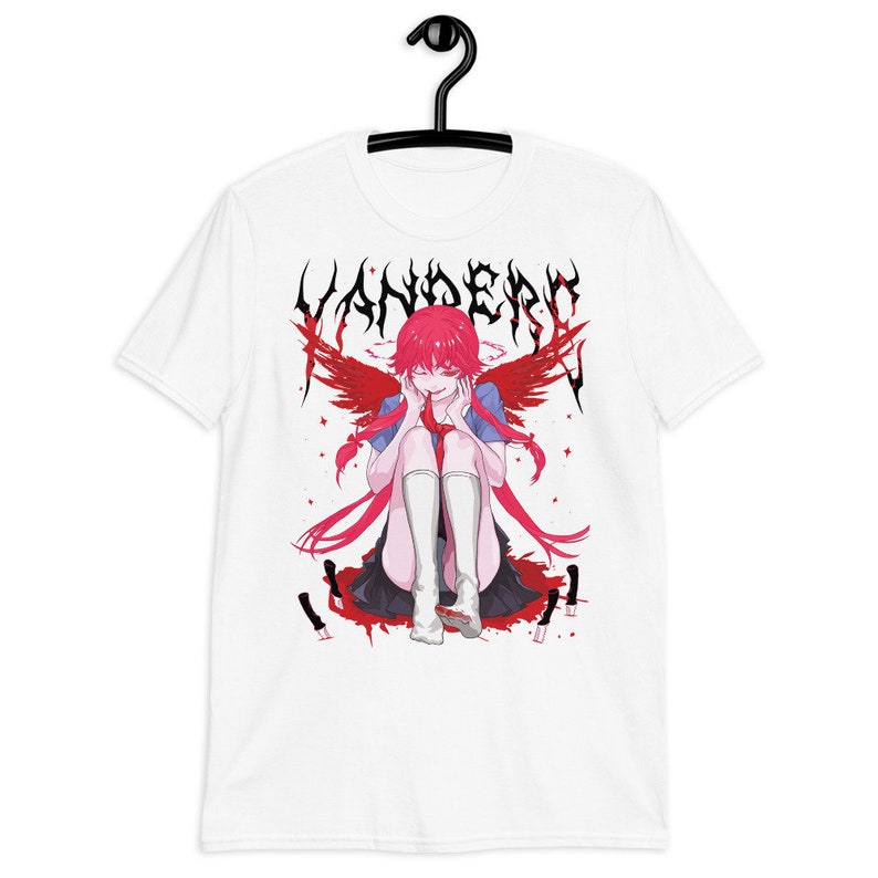 May include: White t-shirt with a graphic print of an anime character with red hair and wings. The character is sitting down with a bloody knife in front of them. The text "Yandere" is printed in black above the character.