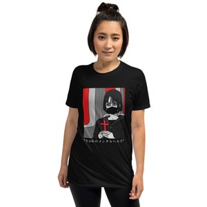 May include: A black short-sleeve t-shirt featuring a graphic print of a person with dark hair wearing a black face mask and holding a red cross. The background of the print includes red and gray vertical stripes and Japanese text at the bottom.