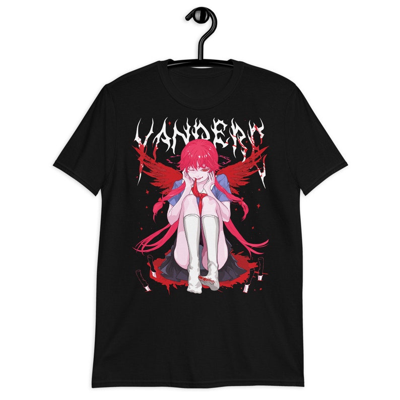 May include: Black t-shirt with a graphic print of an anime character with red hair and wings. The character is sitting on a pool of blood with knives around her. The text "VANDERO" is printed in a metal font above the character.
