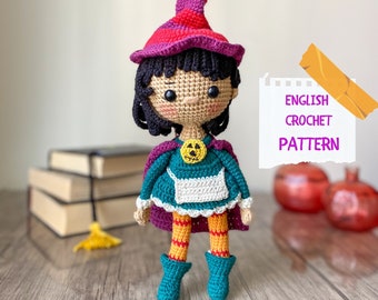 May include: Crocheted Halloween witch doll with a purple and red hat, green dress, orange and yellow striped leggings, and a pumpkin face on her chest. The doll is standing on a wooden surface with books and pumpkins in the background. The text "ENGLISH CROCHET PATTERN" is written on a piece of paper.