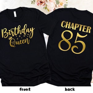 May include: Black t-shirt with gold text that says "Birthday Queen" on the front and "Chapter 85" on the back.