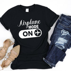 May include: Black t-shirt with white text that reads "Airplane Mode ON" and a white airplane icon.