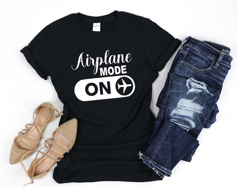 May include: Black t-shirt with white text that reads "Airplane Mode ON" and a white airplane icon.