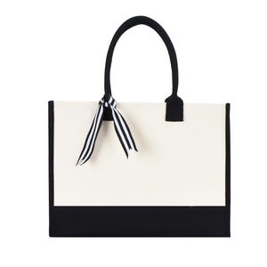 a black and white bag with a bow on it