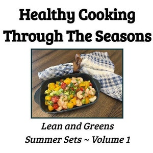 May include: A close-up of a black dish filled with a salad of shrimp, avocado, cherry tomatoes, and yellow tomatoes. The dish is on a wooden surface with a blue and white checkered cloth napkin.