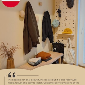 May include: A light-colored wooden pegboard mounted on a wall, featuring multiple pegs and a small shelf. The board holds a black cap, a black umbrella, a light blue hat, a yellow beanie, a black backpack, and a white tote bag.