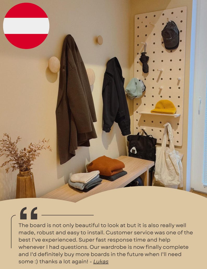 May include: A light-colored wooden pegboard mounted on a wall, featuring multiple pegs and a small shelf. The board holds a black cap, a black umbrella, a light blue hat, a yellow beanie, a black backpack, and a white tote bag.