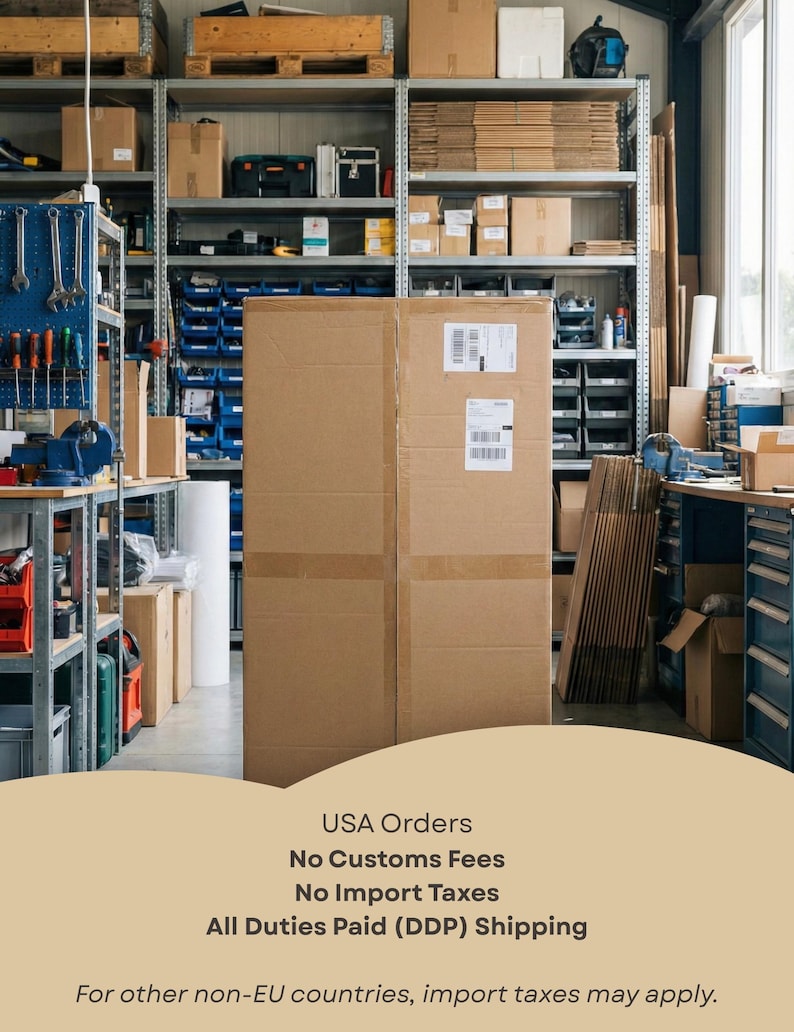May include: A large, rectangular brown cardboard shipping box stands in the center of a warehouse storage area. The box features two white shipping labels on its front surface. The background shows metal shelving units filled with various boxes and tools.