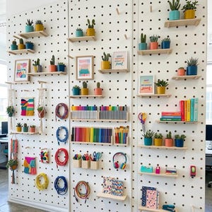 White Modern Wooden Pegboard Wall System for Home Organization and Retail Displays image 3