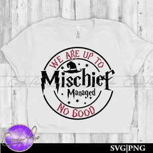 May include: A white t-shirt with a circular graphic in black and red. The graphic reads "We Are Up To Mischief Managed No Good" with a witch hat and stars. The shirt is made of a soft material.