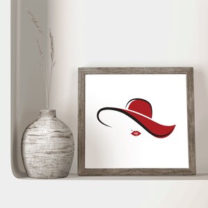 May include: A framed print of a minimalist line drawing of a woman wearing a red hat. The hat is a wide-brimmed sun hat with a simple design.
