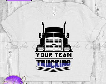 May include: White t-shirt featuring a black silhouette of a semi-truck and the text "YOUR TEAM TRUCKING" in black with a blue stripe.