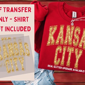 May include: A red sweatshirt with "KANSAS CITY" in gold glitter lettering. The text "REAL GLITTER UPGRADE AVAILABLE!" is below the city name. The image also shows a DTF transfer with the same design and the text "DTF TRANSFER ONLY - SHIRT NOT INCLUDED".