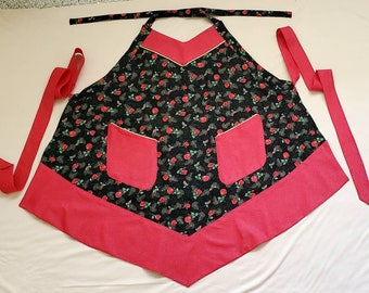 May include: A red and black apron with a floral print and two pockets. The apron has long ties that can be tied around the waist.