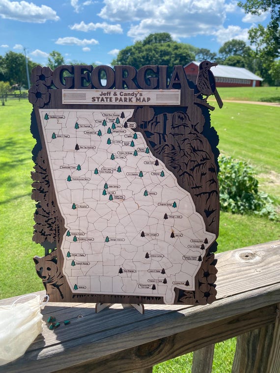 A laser-cut wooden board where outdoorsy folks can physically pin and track every Georgia state park they've conquered — part map art, part adventure log.