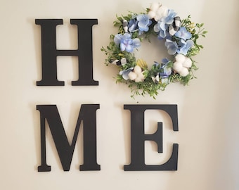 Wood home letters with a wreath. Scroll for other buffalo plaid wreaths.