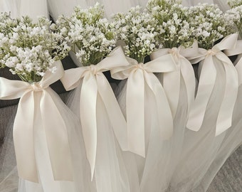 A Set of 10 Ivory pew hangers with Ivory ribbon and babies breath.