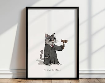 May include: A framed print featuring a cartoon cat dressed as a judge, wearing glasses and a robe, holding a gavel. The artwork is in black and white with a touch of color, and the text "CLAW & order" is written below the cat.