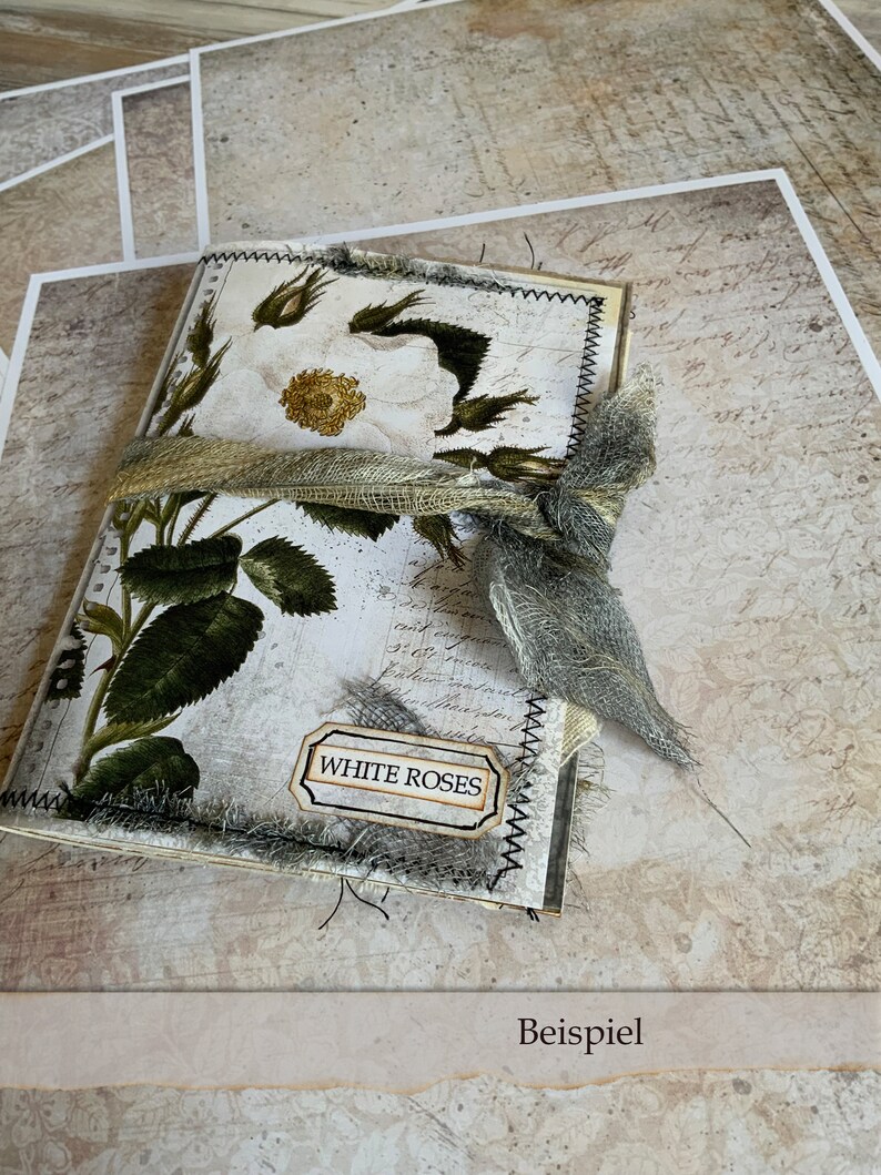 Peut inclure: Un journal fait main avec un motif de rose blanche et un ruban en toile de jute. La couverture est d&eacute;cor&eacute;e d'une &eacute;tiquette qui dit "Roses blanches".