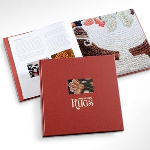 May include: A red hardcover book titled "American Hooked Rugs" with a close-up image of a colorful hooked rug on the front cover.