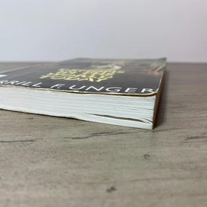 May include: A hardcover book with a black cover and gold lettering. The title "Anything Today" is visible, along with the author's name, "Brill E. Unger". The book's pages are white, and the spine is visible.