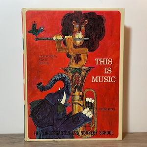 May include: Vintage children's book titled "This Is Music" with a red cover. The cover features illustrations of a lion playing a flute, an elephant playing a tuba, and a bird. Text includes "California State Series" and "For Kindergarten and Nursery School."
