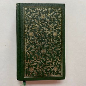 May include: A green hardback book with a gold floral design on the front cover.