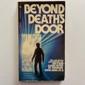 May include: A book cover with a blue and white design. The title is "Beyond Death's Door" and the subtitle is "The Life After Life Bestseller Now A Sunn™ Classic Picture By Maurice Rawlings, M.D."