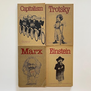 May include: Four vintage books with brown covers and red lettering. The titles are "Capitalism," "Trotsky," "Marx," and "Einstein," all with "For Beginners." Each cover features a black and white illustration related to the title.