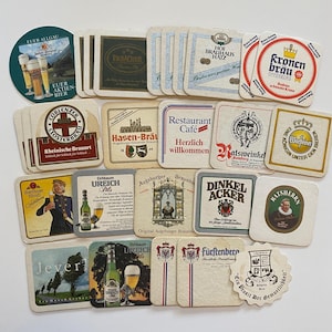 May include: A collection of colorful coasters featuring various German brewery logos and names, including "Eichbaum Ureich", "Hasen-Bräu", "Jever", "Kronen Brau", "Dinkel Acker", "Ratsweinkel", "Fürstenberg", "Hof Brauhäus Hatz", and "Eurer Allgau".