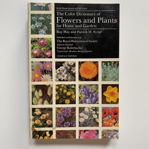 以下が含まれることがあります： 家庭と庭のための、花と植物の色辞書。カラフルな表紙に18枚の花の画像がグリッド状に並んでいます。ロイヤル・ホticultural協会との共同出版です。