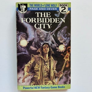 May include: The cover of a fantasy game book titled "The Forbidden City" from the "World of Lone Wolf" series. The cover features a man with long brown hair holding a staff, surrounded by three creatures with glowing orbs.
