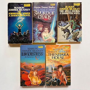May include: A collection of five paperback fantasy novels by Marion Zimmer Bradley. The books are titled "The Forbidden Tower", "Sword of Chaos", "The Spell Sword", "Hawk Mistress", and "Thendara House".