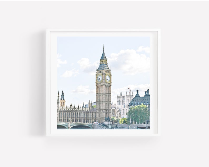 May include: A photograph of Big Ben, the iconic clock tower in London, England. The tower is a pale yellow with a black clock face and a pointed spire. The tower is surrounded by other buildings, including the Houses of Parliament.