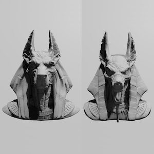 Puede incluir: Se muestran dos bustos en escala de grises de Anubis, el dios egipcio del más allá. Los bustos representan la figura con cabeza de chacal con rasgos faciales detallados, que lleva una cofia y un collar. Las esculturas están sobre un fondo liso.