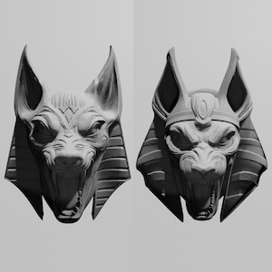 May include: Two grayscale sculptures of Anubis, the Egyptian god of the afterlife, are displayed. The sculptures feature the jackal-headed figure with detailed facial features, large ears, and open mouths, showcasing intricate craftsmanship.