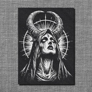 May include: Black and white illustration of a figure with large horns, a cross on the forehead, and tears. The figure is framed by a halo and wears a hooded cloak. The artwork is on a black background.
