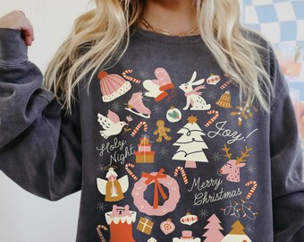 May include: A dark gray sweatshirt with a festive Christmas design featuring a variety of holiday icons, including a Christmas tree, presents, candy canes, a stocking, and a wreath. The text "Holy Night", "Joy!" and "Merry Christmas" is printed on the sweatshirt.