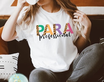 May include: White t-shirt with the words "PARA professional" printed on it. The letters are in a leopard print pattern and are outlined in different colours.
